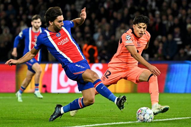 PSG's Spanish forward #09 Ferran Torres (L) and Barcelona's Spanish defender #12 Xavi Espart run for the ball during the UEFA Champions League first round day 3 football match between Paris Saint-Germain (PSG) and FC Barcelona at the Parc de Princes stadium in Paris on October 20, 2026. (Photo by JULIEN DE ROSA / AFP)