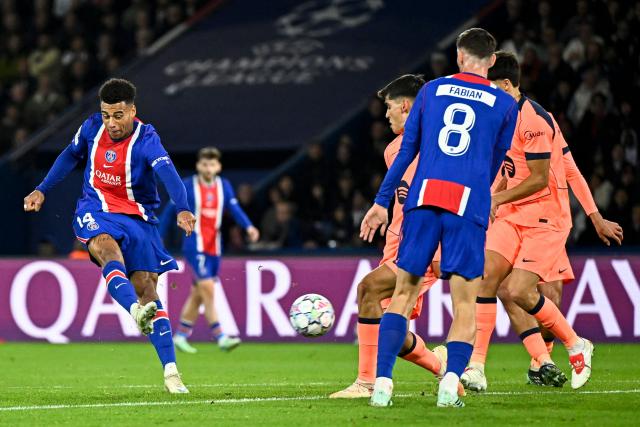 PSG's French forward #14 Desire Doue (L) shoots to score his team's first goal during the UEFA Champions League first round day 3 football match between Paris Saint-Germain (PSG) and FC Barcelona at the Parc de Princes stadium in Paris on October 20, 2026. (Photo by JULIEN DE ROSA / AFP)