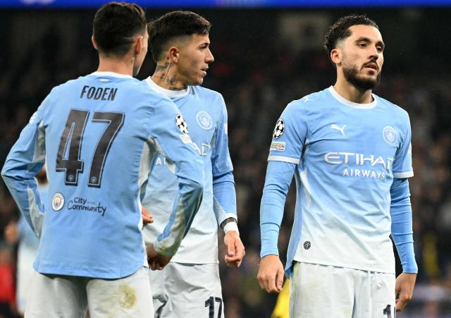 Manchester City's English midfielder #47 Phil Foden (L) and Manchester City's Argentinian midfielder #17 Enzo Fernandez (2L) react as Manchester City's French midfielder #10 Rayan Cherki (C) celebrates scoring the team's third goal during the UEFA Champions League football match between Manchester City and AEK Athens at the Etihad Stadium in Manchester, north west England, on October 20, 2026. (Photo by Oli SCARFF / AFP)