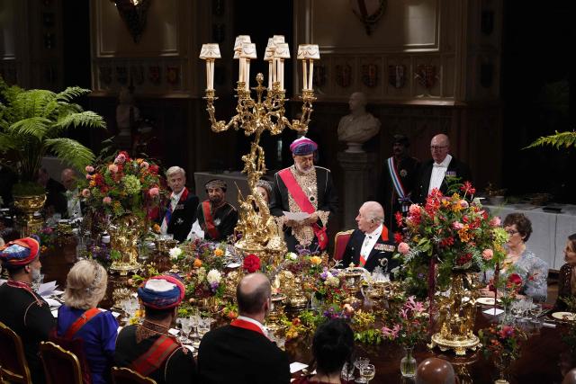 Britain's King Charles III listens as Oman's Sultan Haitham bin Tarik (C) stands whilst making a speech during the State Banquet at Windsor Castle, Windsor, on October 20, 2026, the first day of a three-day State Visit to the United Kingdom by The Sultan of Oman. (Photo by Jordan Pettitt / POOL / AFP)