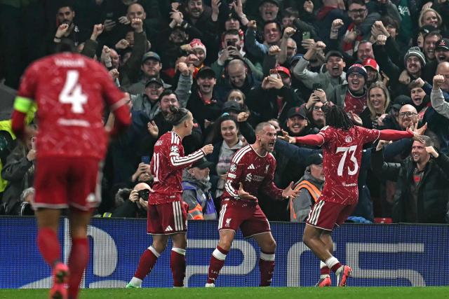 Liverpool's Argentinian midfielder #10 Alexis Mac Allister (C) celebrates scoring the team's third goal during the UEFA Champions League football match between Liverpool and Villareal at Anfield in Liverpool, north west England on October 20, 2026. (Photo by Paul ELLIS / AFP)