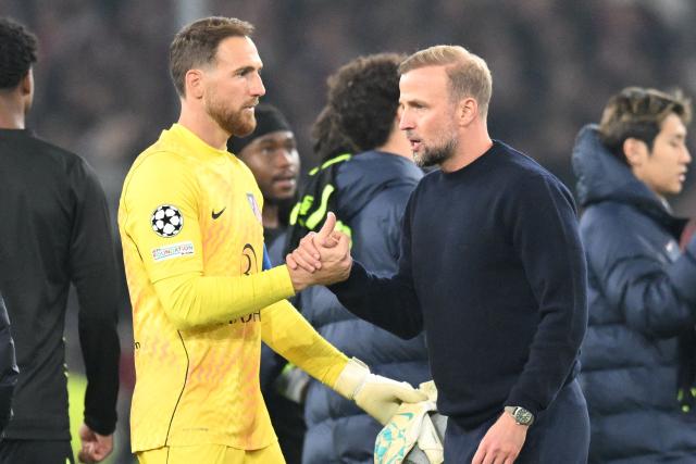 Stuttgart's German head coach Sebastian Hoeness shakes hands with Atletico Madrid's Slovenian goalkeeper #13 Jan Oblak after the UEFA Champions League football match VfB Stuttgart v Atletico Madrid in Stuttgart, southern Germany, on October 20, 2026. (Photo by THOMAS KIENZLE / AFP)