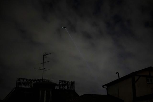 This photograph shows a helicopter patroling over central Paris to enforce a partial curfew of the capital, in Paris, on October 20, 2026, after weekend demonstrations over soaring prices degenerated into some of the worst street violence in recent years. Paris police ordered a new curfew for parts of the city for October 20, after a curfew on the previous night that authorities said resulted in calm being restored following weekend riots and looting. The fresh curfew runs from 2100 GMT on October 20, 2026 to 0400 GMT October 21, 2026 and applies to the Republique public square in the city's central east, where many weekend clashes took place, and in the central les Halles district which is full of shops as well as nearby train stations. (Photo by Olivier MORIN / AFP)