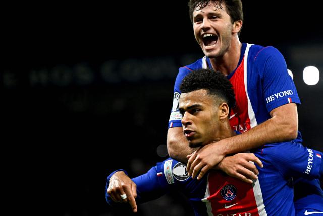 PSG's French forward #14 Desire Doue (L) celebrates with teammate PSG's Portuguese midfielder #87 Joao Neves after scoring his team's first goal during the UEFA Champions League first round day 3 football match between Paris Saint-Germain (PSG) and FC Barcelona at the Parc de Princes stadium in Paris on October 20, 2026. (Photo by JULIEN DE ROSA / AFP)