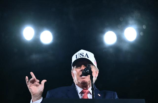 US President Donald Trump speaks at a midterm campaign rally at Pitt-Greenville Airport in Greenville, North Carolina, on October 20, 2026. (Photo by Kent NISHIMURA / AFP)