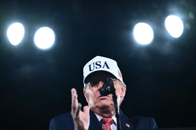 US President Donald Trump speaks at a midterm campaign rally at Pitt-Greenville Airport in Greenville, North Carolina, on October 20, 2026. (Photo by Kent NISHIMURA / AFP)