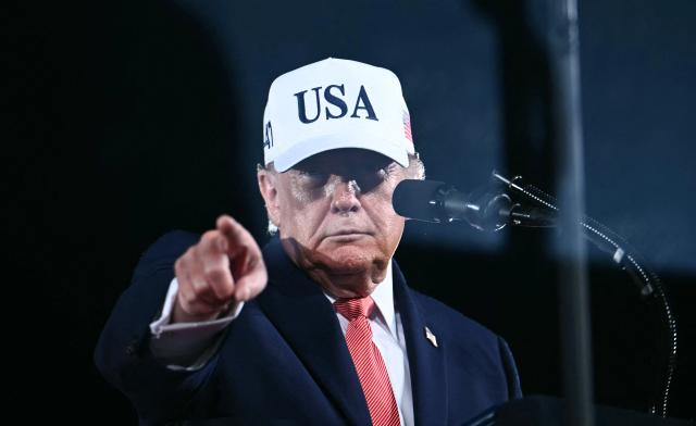 US President Donald Trump points as he speaks at a midterm campaign rally at Pitt-Greenville Airport in Greenville, North Carolina, on October 20, 2026. (Photo by Kent NISHIMURA / AFP)