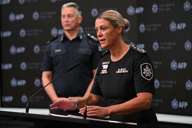Commissioner of the Australian Federal Police Krissy Barrett (R) speaks alongside Chief Commissioner of Victoria Police, Mike Bush (L) during a press conference for an update on the attack on Australian politician Helen Haines, in Melbourne on October 21, 2026. The man alleged to have critically wounded Australian lawmaker Helen Haines in a "targeted" attack appeared in court on October 21, as police warned that growing extremism online was fuelling political polarisation. (Photo by William WEST / AFP)