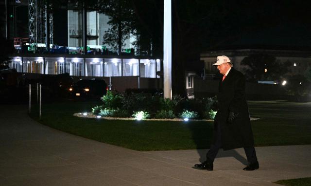 US President Donald Trump walks on the South Lawn upon arrival at the White House in Washington, DC, on October 20, 2026. President Trump is returning from campaigning in North Carolina. (Photo by Jim WATSON / AFP)