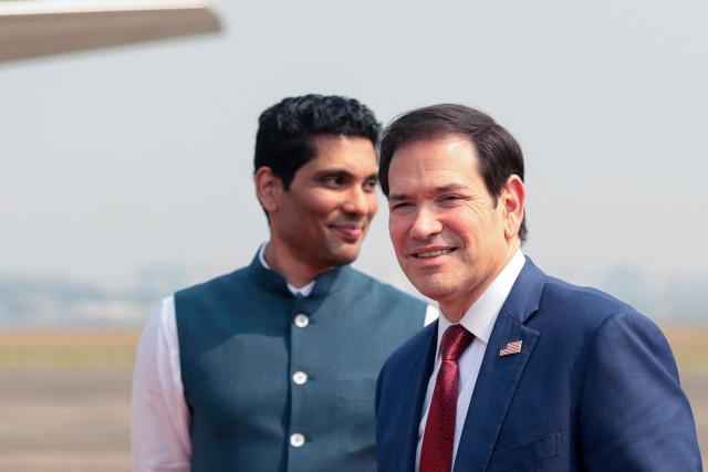 US Secretary of State Marco Rubio (R) arrives to board a plane en route to Jamnagar, at  Chhatrapati Shivaji Maharaj International Airport in Mumbai on October 21, 2026. (Photo by KYLIE COOPER / POOL / AFP)