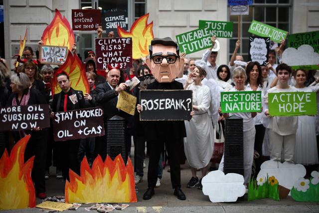 (FILES) Protesters hold up placards outside the Department of Energy in central London on October 6, 2026, demonstrating against the proposed development of the Rosebank and Jackdaw oil fields in the North Sea, north-west of Scotland. Britain's government announced on October 21, 2026 it had approved plans to begin drilling in a controversial gas field in the North Sea, ending months of speculation about the future of the divisive project. (Photo by Henry Nicholls / AFP)