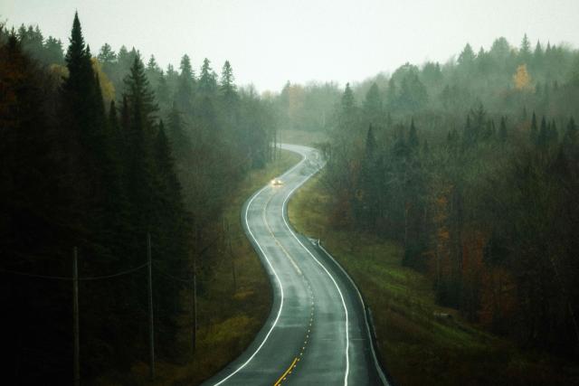 TOPSHOT - A car drives on Route 11 near Masardis, Maine, on October 13, 2026. (Photo by CHARLY TRIBALLEAU / AFP)