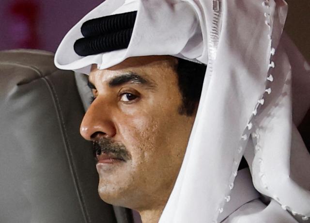 Qatar's Emir Sheikh Tamim bin Hamad al-Thani looks on while attending the 9th Annual One Planet Sovereign Wealth Funds (OPSWF) Summit with the French president at the Rosewood Hotel in Lusail on October 21, 2026. The French president is undertaking a tour of key energy suppliers in the Gulf in an effort to secure oil and diesel and bring down prices in France. (Photo by Benoit Tessier / POOL / AFP)