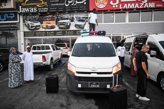 Travellers prepare to depart by road for Saudi Arabia in a minibus from Doha on October 21, 2026. Saudi Arabia has this month come under sustained attack from the Iran-backed Houthis, including a strike on Riyadh's international airport that was the kingdom's deadliest in years, as the war with the group escalates. (Photo by Mahmud HAMS / AFP)