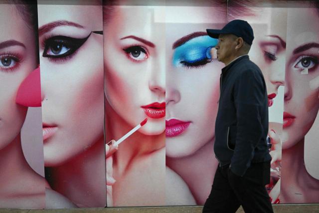 A man walks past a cosmetics store in Beijing on October 21, 2026. (Photo by Pedro PARDO / AFP)
