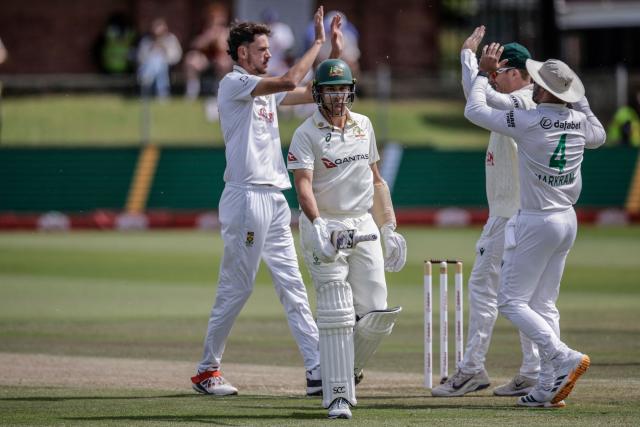 South Africa's Marco Jansen (L) celebrates with his teammates after dismissing Australia's Scott Boland (2nd L) on day four of the second Test match between South Africa and Australia at St Georges Park in Gqeberha on October 21, 2026. (Photo by Marco Longari / AFP)