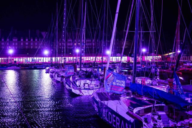 This photograph shows boats docked at night in the harbour of Saint-Malo, western France on October 20, 2026, a few days before the start of the 13th Route du Rhum Destination Guadeloupe. From Saint-Malo in Brittany to Pointe-a-Pitre in Guadeloupe, over 100 skippers across 6 classes will take the start on November 1, 2026, in this solo transatlantic sailing race. (Photo by Martin BUREAU / AFP)