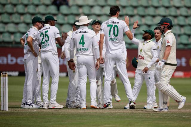 South Africa's Marco Jansen (4th R) celebrates with teammates after dismissing Australia's Travis Head (R) on day four of the second Test match between South Africa and Australia at St Georges Park in Gqeberha on October 21, 2026. (Photo by Marco Longari / AFP)