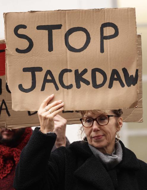 Demonstrators hold anti-Jackdaw placards as they demonstrate against further drilling for oil and gas in the North Sea, outside the Department for Energy Security and Net Zero in central London on October 21, 2026. Britain's government announced on October 21, 206, it had approved plans to begin drilling in a controversial gas field in the North Sea, ending months of speculation about the future of the divisive project. The decision to allow drilling in the Jackdaw field, about 150 miles (240 kilometres) east of Aberdeen was welcomed by industry groups but criticised by environmentalists who said it would worsen carbon emissions. (Photo by Brook Mitchell / AFP)
