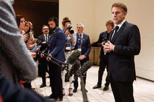 France's President Emmanuel Macron speaks to members of the media on the day of the 9th Annual One Planet Sovereign Wealth Funds (OPSWF) Summit in Lusail on October 21, 2026. The French president is undertaking a tour of key energy suppliers in the Gulf in an effort to secure oil and diesel and bring down prices in France. (Photo by Benoit Tessier / POOL / AFP)