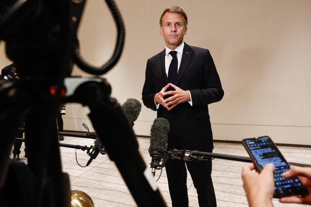 France's President Emmanuel Macron speaks to members of the media on the day of the 9th Annual One Planet Sovereign Wealth Funds (OPSWF) Summit in Lusail on October 21, 2026. The French president is undertaking a tour of key energy suppliers in the Gulf in an effort to secure oil and diesel and bring down prices in France. (Photo by Benoit Tessier / POOL / AFP)