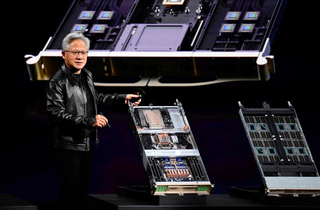Co-founder, President and CEO of US technology company Nvidia, Jensen Huang delivers his keynote speech next to computer components during the Nvidia GTC Berlin 2026 Artificial Intelligence conference, on October 21, 2026 in Berlin. (Photo by John MACDOUGALL / AFP)