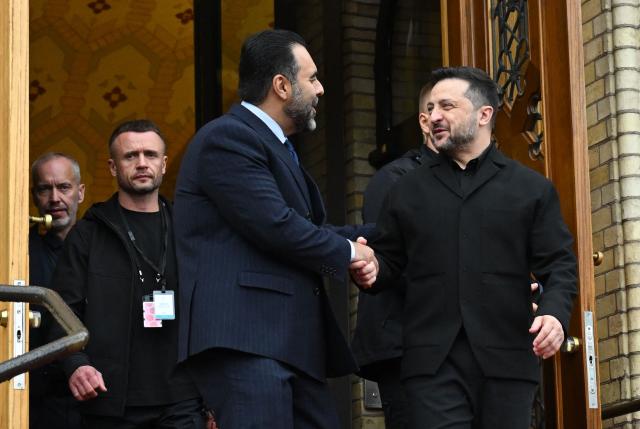 Ukraine's President Volodymyr Zelensky (R) shakes hands with Masud Gharahkhani, the President of Norway's Parliament (Storting), as he visits the parliament to attend a session on October 21, 2026, one day after a meeting in the Norwegian capital on the situation in Ukraine. Ukrainian President Volodymyr Zelensky arrived in Oslo on October 20, 2026 for talks with top US envoys. (Photo by Jonathan Nackstrand / AFP)
