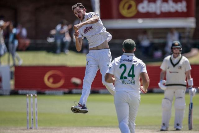 South Africa's Marco Jansen (L) jumps in air to celebrate after dismissing Australia's Alex Carey on day four of the second Test match between South Africa and Australia at St Georges Park in Gqeberha on October 21, 2026. (Photo by Marco Longari / AFP)