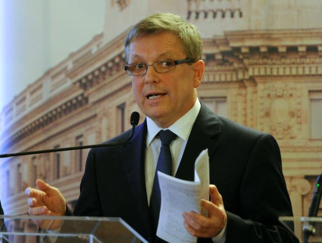 (FILES) Then new governor of the Hungarian Central Bank (MNB) Gyorgy Matolcsy informs the press about their new financial deal in the main hall of the MNB headquarters in Budapest on April 4, 2013 during his first official press conference in his new position. Hungary's former central bank governor -- once a close ally of ex-leader Viktor Orban -- was detained on October 21, 2026, his lawyer told local media, in one of the country's most high-profile graft cases. Gyorgy Matolcsy, 71, who headed the Hungarian National Bank (MNB) between 2013 and 2025, was taken into custody in connection with a sprawling scandal surrounding his tenure, his lawyer Pal Batki told news site Telex. (Photo by Attila KISBENEDEK / AFP)