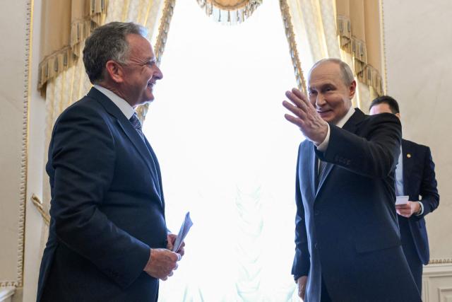 In this pool photograph distributed by the Russian state agency Sputnik, Russia's President Vladimir Putin (R) greets US special envoy Steve Witkoff (L) prior to their meeting in Saint Petersburg on October 21, 2026. (Photo by Kristina Solovyova / POOL / AFP) / Editor's note: This image is distributed by the Russian state owned agency Sputnik