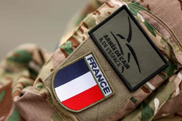 This photograph shows a badge displaying the the emblem of the French Air and Space Force on the arm of a soldier during joint training at Zagreb Air Base in Pleso, near Zagreb on October 21, 2026. The training is part of FRA-ACE 26 (French Agile Combat Employment), marking the first deployment to Croatia of Rafale aircraft from France's 5th Fighter Wing and focusing on rapid deployment and operations with a reduced logistical footprint. Croatian Rafale pilots and aircraft technicians from the 91st Wing are also training alongside their French counterparts, exchanging operational and technical experience. (Photo by Goran Stanzl / AFP)