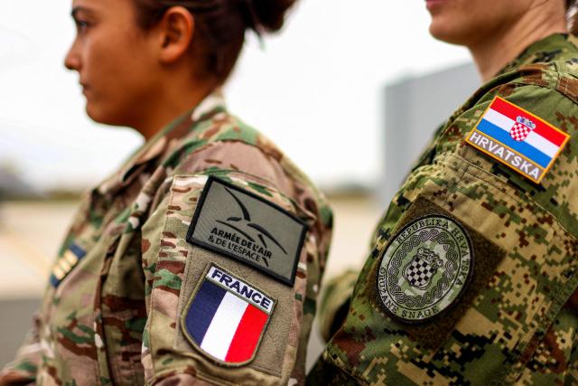 Military personnel from the Croatian Air Force and the French Air and Space Force stand during joint training at Zagreb Air Base in Pleso, near Zagreb on October 21, 2026. The training is part of FRA-ACE 26 (French Agile Combat Employment), marking the first deployment to Croatia of Rafale aircraft from France's 5th Fighter Wing and focusing on rapid deployment and operations with a reduced logistical footprint. Croatian Rafale pilots and aircraft technicians from the 91st Wing are also training alongside their French counterparts, exchanging operational and technical experience. (Photo by Goran Stanzl / AFP)