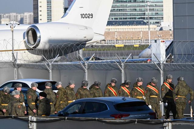 Russian honor guard soldiers stand in a parking lot as a Bombardier aircraft reportedly carrying US special envoy is being prepared for takeoff from Pulkovo Airport in Saint Petersburg on October 21, 2026. Moscow is ready to resume trilateral US-Ukraine-Russia talks next month, the Kremlin said on October 21, 2026 after Russia'a President met with US envoy in Russia. (Photo by Olga MALTSEVA / AFP)