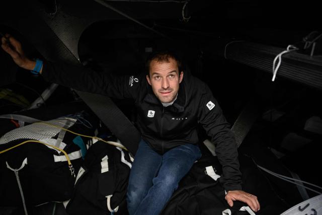 British skipper Sam Goodchild poses for a photo session aboard his Imoca monohull Macif at the village of the Route du Rhum - Destination Guadeloupe, a few days prior to the start of this solo sailing race from Saint-Malo, western France to Pointe-a-Pitre in the French overseas island of Guadeloupe, in Saint-Malo, western France, on October 21, 2026. (Photo by Loic VENANCE / AFP)
