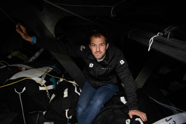 British skipper Sam Goodchild poses for a photo session aboard his Imoca monohull Macif at the village of the Route du Rhum - Destination Guadeloupe, a few days prior to the start of this solo sailing race from Saint-Malo, western France to Pointe-a-Pitre in the French overseas island of Guadeloupe, in Saint-Malo, western France, on October 21, 2026. (Photo by Loic VENANCE / AFP)