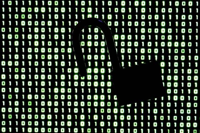 An illustration picture taken on October 21, 2026 shows a padlock in front of binary code on a laptop screen in Frankfurt am Main, western Germany. (Photo by Kirill KUDRYAVTSEV / AFP)