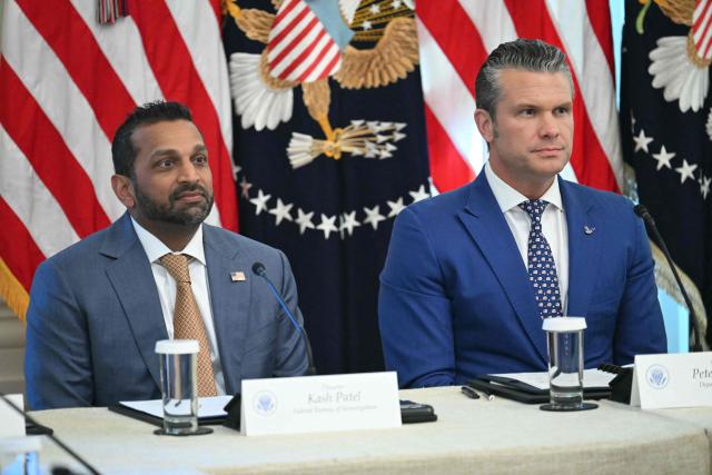 (L-R) FBI Director Kash Patel and US Defense Secretary Pete Hegseth  attend a roundtable in the East Room of the White House in Washington, DC on October 21, 2026. (Photo by SAUL LOEB / AFP)