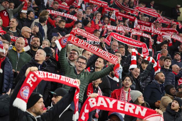 Bayern fans display their scarves prior to the UEFA Champions League football match between FC Bayern Munich and Arsenal FC in Munich, southern Germany on October 21, 2026. (Photo by Karl-Josef HILDENBRAND / AFP)