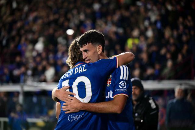 Como's Spanish defender #04 Jacobo Ramon (R) celebrates scoring his team's fourth goal with Como's Argentine midfielder #10 Nicolas Paz (L) during the UEFA Champions League, league phase matchday 3, football match between Como 1907 and Manchester United at the Stadio Giuseppe Sinigaglia in Como, northen Italy on October 21, 2026. (Photo by Marco BERTORELLO / AFP)
