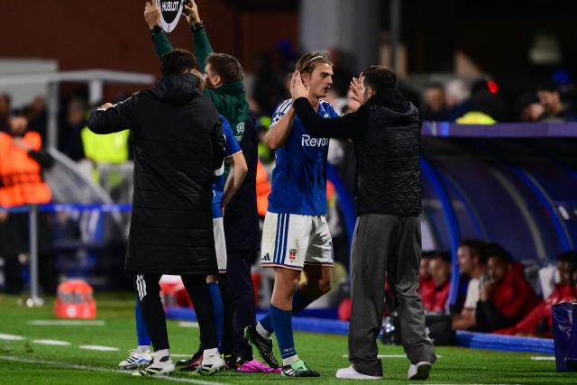 Como's Argentine midfielder #10 Nicolas Paz (2nd R) leaves the pitch for a substitude as he embraces Como's Spanish head coach Cesc Fabregas during the UEFA Champions League, league phase matchday 3, football match between Como 1907 and Manchester United at the Stadio Giuseppe Sinigaglia in Como, northen Italy on October 21, 2026. (Photo by Marco BERTORELLO / AFP)