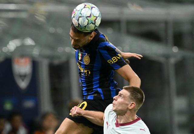 Inter Milan's Turkish midfielder #20 Hakan Calhanoglu fights for the ball with Shakhtar Donetsk's Ukrainian midfielder #27 Oleh Ocheretko during the UEFA Champions League first round day 3 football match between Inter Milan and Shakhtar Donetsk at San Siro stadium in Milan, on October 13, 2026 (Photo by Stefano Rellandini / AFP)