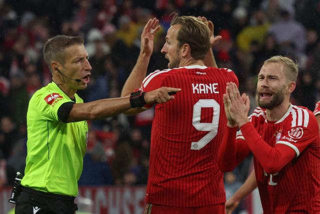 Bayern Munich's Austrian midfielder #27 Konrad Laimer (R) and Bayern Munich's English forward #09 Harry Kane plead with Italian referee Davide Massa during the UEFA Champions League football match between FC Bayern Munich and Arsenal FC in Munich, southern Germany on October 21, 2026. (Photo by Karl-Josef HILDENBRAND / AFP)