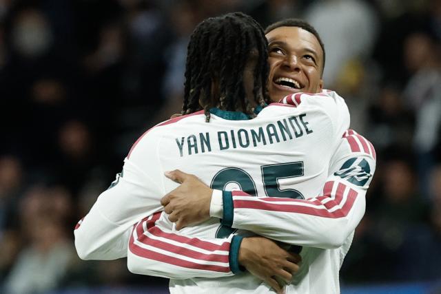 Real Madrid's French forward #10 Kylian Mbappe (R) celebrates scoring his team's third goal with Real Madrid's Ivorian forward  #25 Yan Diomande during their UEFA Champions League first round day 3 football match between Real Madrid CF and RB Leipzig at the Santiago Bernabeu stadium in Madrid on October 21, 2026. (Photo by Oscar DEL POZO / AFP)