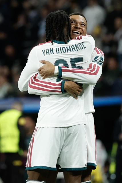 Real Madrid's French forward #10 Kylian Mbappe (R) celebrates scoring his team's third goal with Real Madrid's Ivorian forward  #25 Yan Diomande during their UEFA Champions League first round day 3 football match between Real Madrid CF and RB Leipzig at the Santiago Bernabeu stadium in Madrid on October 21, 2026. (Photo by Oscar DEL POZO / AFP)