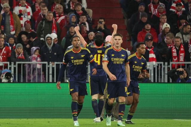 Arsenal's English midfielder #41 Declan Rice (C) celebrates scoring the 2-2 goal with his teammates Arsenal's Brazilian defender #06 Gabriel Magalhaes (L) and Arsenal's Swedish striker #14 Viktor Gyokeres during the UEFA Champions League football match between FC Bayern Munich and Arsenal FC in Munich, southern Germany on October 21, 2026. (Photo by Karl-Josef HILDENBRAND / AFP)