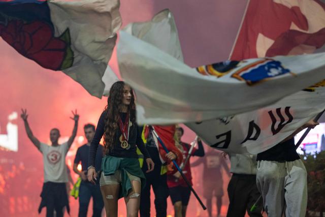 Students celebrate as they arrive in central Belgrade on October 21, 2026, after walking for several days to attend the student movement's final major rally, due to be held in the capital the following day, ahead of Serbia's October 25 snap elections. The student-led movement emerged from nationwide protests following the November 2024 collapse of a railway station canopy in Novi Sad that killed 16 people, with demands expanding to include early elections in May 2025. The student movement formally entered the electoral race in September, challenging the Serbian Progressive Party (SNS). (Photo by Andrej ISAKOVIC / AFP)