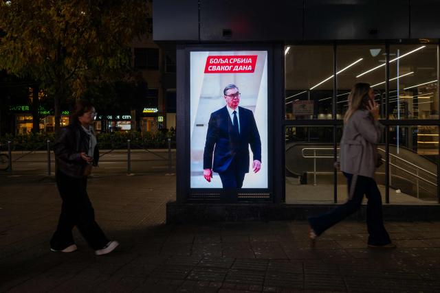 An illuminated election campaign billboard featuring Aleksandar Vucic, candidate for prime minister for the Serbian Progressive Party (SNS), and bearing the slogan "A Better Serbia Every Day", is pictured in central Belgrade on October 21, 2026, ahead of Serbia's October 25 snap elections. The student-led movement emerged from nationwide protests following the November 2024 collapse of a railway station canopy in Novi Sad that killed 16 people, with demands expanding to include early elections in May 2025. The student movement formally entered the electoral race in September, challenging the Serbian Progressive Party (SNS). (Photo by Andrej ISAKOVIC / AFP)