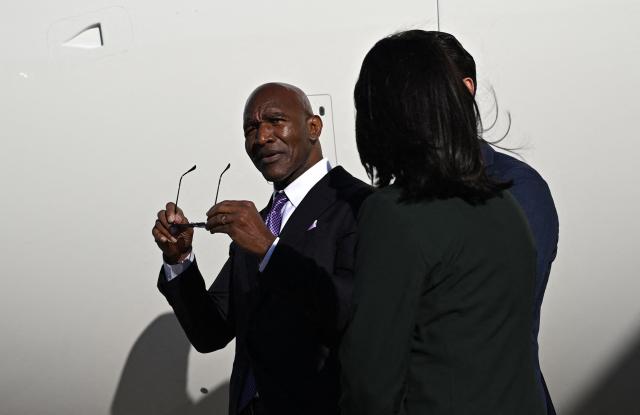 Former professional boxer Evander Holyfield waits on the tarmac after disembarking from Air Force One upon arrival at Greenville-Spartanburg International Airport in Greer, South Carolina on October 21, 2026. (Photo by Kent NISHIMURA / AFP)