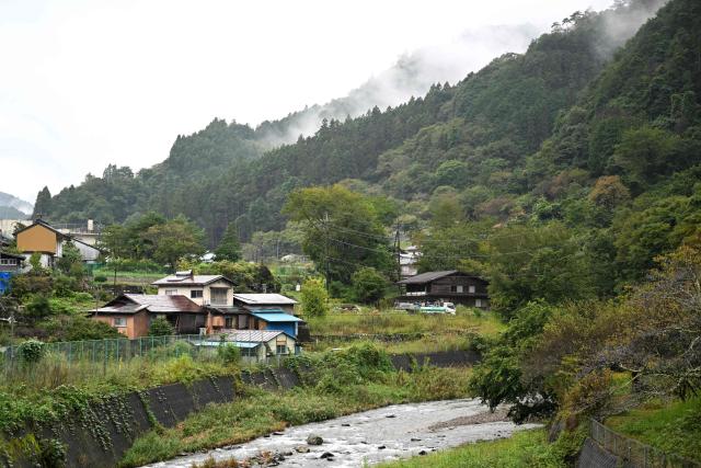 A general view of Nanmoku village, Gunma prefecture is seen on September 26, 2026. In a misty mountain village in Japan, residents recently welcomed unlikely guests from a Peruvian district along the Amazon River, seeing a chance to revive an ageing community facing extinction. Nanmoku village officials hope a sister-city agreement, which promotes cultural and people-to-people ties, will ultimately attract young people from Belen to live in Nanmoku, although how they might obtain residency remains unclear. (Photo by Rie KIKUCHI / AFP) / To go with AFP story Japan-Peru-social-population-demographics, FOCUS by Natsuko Fukue and Junior Raborg