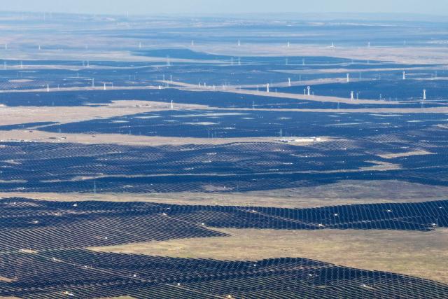 Solar panels are seen at the Ningdong 2-million-kilowatt hybrid photovoltaic base in Yinchuan, in China’s northern Ningxia region on October 21, 2026. (Photo by CN-STR / AFP) / China OUT